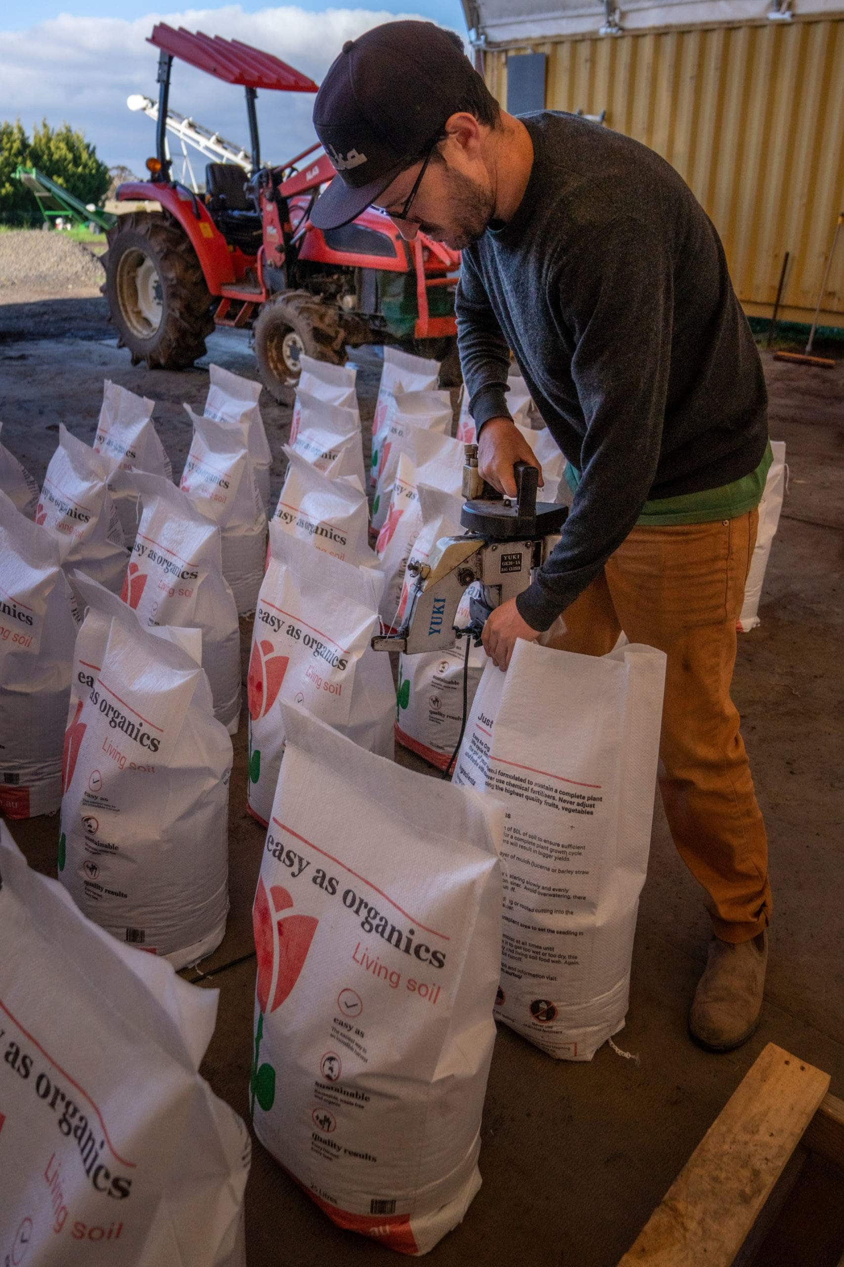 Photo of young man bagging Easy as Organics Living Soil