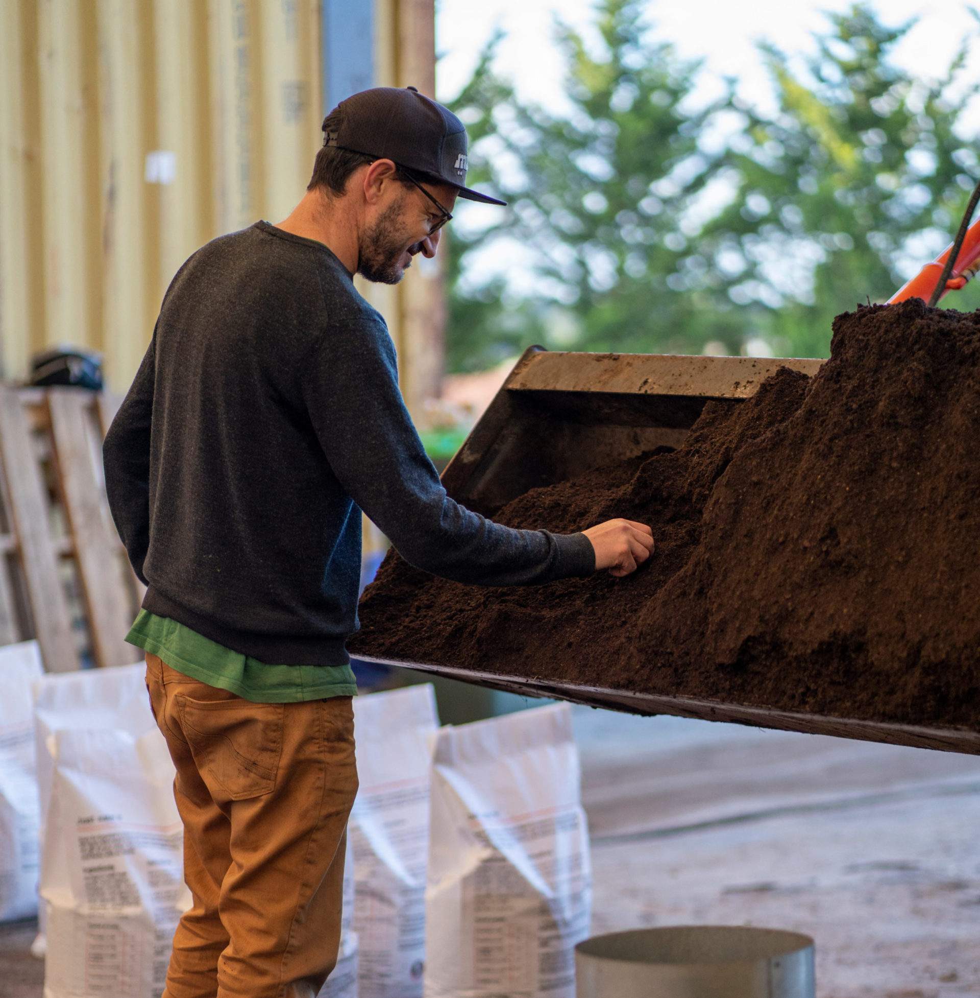 Photograph of man checking the quality of living soil